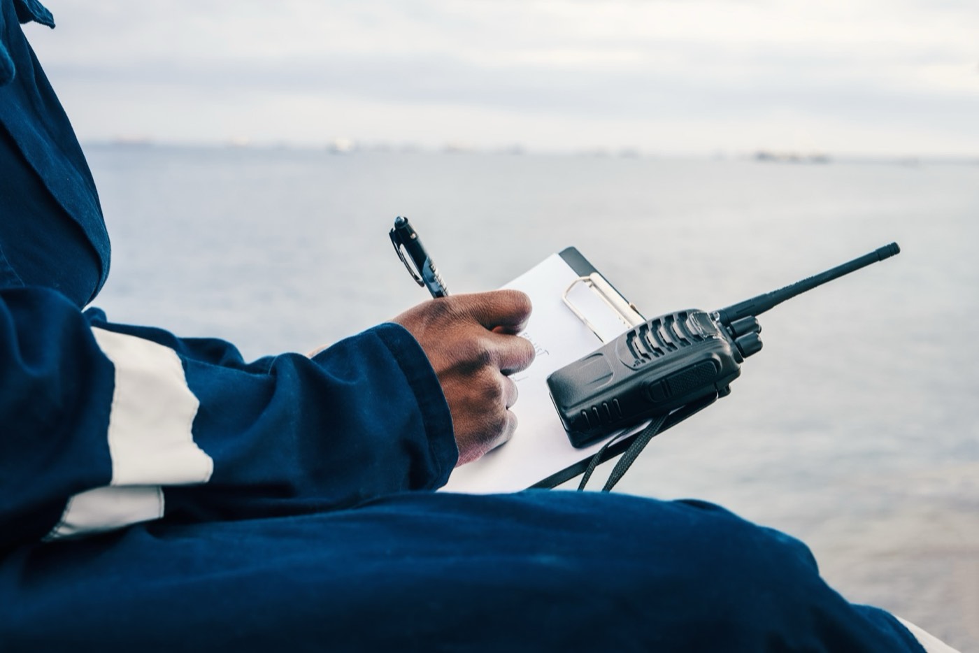 Crew member logging operations by the water